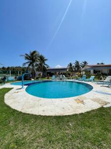 a large swimming pool in the middle of a yard at Casa de Praia Panaquatira - São J. Ribamar in São-José-do-Ribamar