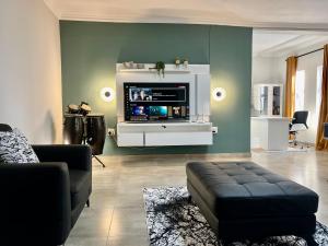 a living room with a tv on a wall at 435 on vale boutique aparthotel in Johannesburg