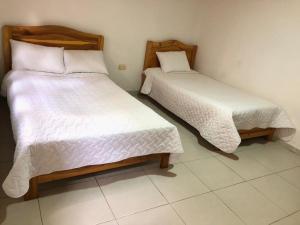 Postel nebo postele na pokoji v ubytování Hospedaje Casa Lola