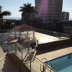 a swimming pool with a gazebo on a building at Apart hotel otima localizaçao em Brasilia in Brasilia