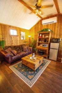 a living room with a couch and a coffee table at A Barn At The Quarry in Fredericksburg