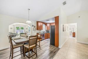 a kitchen and dining room with a table and chairs at Beautiful Home Away From Home in Royal Palm Beach