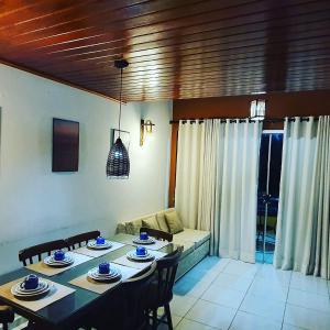 a living room with a table and chairs and a couch at Gravatá sonho de estadia - 928 in Gravatá