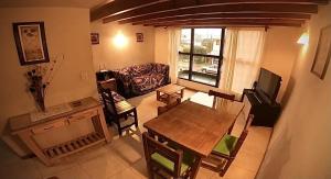 a living room with a table and a couch at Depto Elordi in San Martín de los Andes