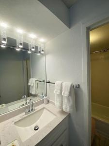 a bathroom with a sink and a mirror at Little Paradise in Waikiki with Lovely Ocean -15F in Honolulu