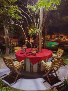 a table with a red tablecloth and chairs around it at Bikini Hotel & Pool in Palomino