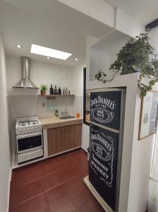 uma cozinha com uma placa de quadro ao lado de um fogão em Bed & bikes Mendoza em Mendoza