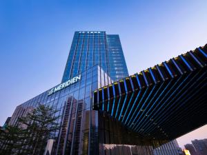 a building with a sign on the side of it at Le Meridien Zhongshan in Zhongshan