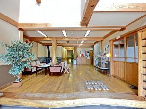 a large living room with a table and chairs at Sendaiya in Hida