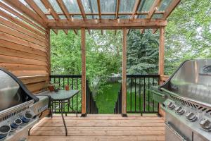 a screened in porch with a grill and a table at FREE PARKING PRIME LOCATION NEW MODERN CONDO in Brossard
