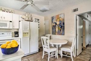 a kitchen with a table and a kitchen with a white refrigerator at Gulfside Resort. Unit 3 in St. Pete Beach
