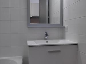 a white bathroom with a sink and a mirror at Studio Villard-de-Lans, 1 pièce, 4 personnes - FR-1-689-124 in Villard-de-Lans