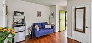 a living room with a blue couch in a room at Studio Mins to LAX , Venice Beach & Sony Studios CC B in Los Angeles