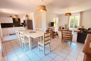 eine Küche und ein Wohnzimmer mit einem Tisch und Stühlen in der Unterkunft Cozy house with garden in La Teste-de-Buch in La Teste-de-Buch