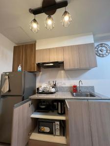 ダバオシティにあるINSPIRIA TOWER CONDOMINIUM 1211のシンクと冷蔵庫付きのキッチン
