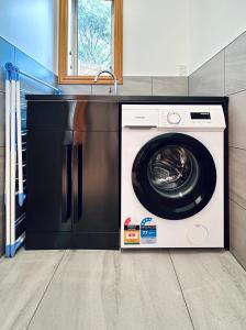 uma máquina de lavar e secar roupa numa cozinha em The Shan's Lodge em Queenstown