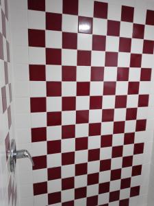 a bathroom with a red and white checkered floor at Cozy Basement Apartment, 40-Min Drive to NY City in Irvington