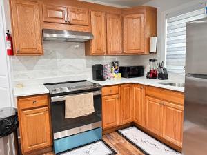 a kitchen with wooden cabinets and a stove top oven at Serene Escape Leave Worries Behind in Wilkes-Barre