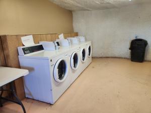 a laundry room with three washing machines in it at Sova in Valle