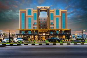 a hotel with cars parked in front of it at Beach View Hotel in Dammam