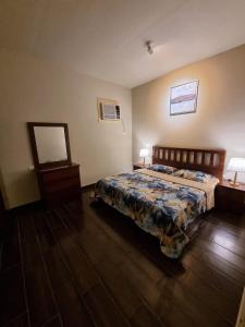 a bedroom with a bed and a table and a mirror at Valley Villa in Jeddah