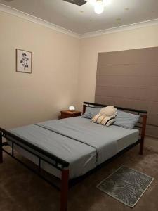 a bedroom with a bed in a room at Private self check in home in Alice Springs