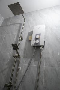 a shower in a bathroom with a machine on the floor at Empire House, Phnom Penh in Phnom Penh