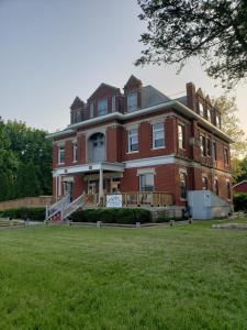 a large red brick house with a large yard at Beatrice The Villa in Marion