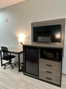 a large entertainment center with a desk and a television at Crosby Travel Lodge and RV Park in Crosby