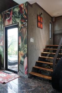 a staircase in a room with a colorful wall at Nam Du Travel in Nam Du