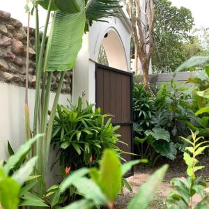 a wooden gate in a garden with plants at Nam Du Travel in Nam Du