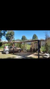 a car parked in a parking lot with a fence at GARDENIAHOSPEDAJE in El Ceibal +15 photos