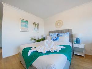 a bedroom with a bed with a flower on it at Charming Burleigh Studio in Gold Coast +7 photos
