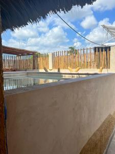 a patio with a fence and a pool with a table at Hotel Casa-Noria Acapulco in Acapulco