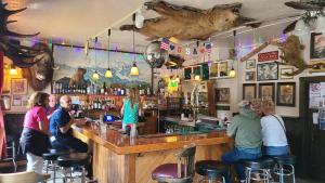 a group of people sitting at a bar at The Fairview Inn in Talkeetna