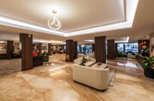 a lobby with couches and chairs in a building at Beach View Hotel in Dammam