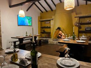 a dining room with a table and a fireplace at La Villa de San Sebastian Hotel in Villa de Leyva