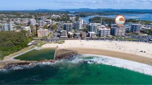 an aerial view of a beach and a city at Ebbtide Unit 34 in Forster