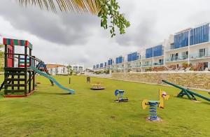 a playground with slides and play equipment in a yard at Cana Rock Star Pool View Whith BBQ in Punta Cana