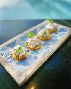 four pastries with cream cheese and parsley on a plate at Cana Rock Star Pool View Whith BBQ in Punta Cana