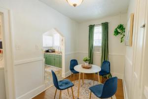a dining room with blue chairs and a table at Historic Revival King Bed Midtown Memphis 70 Fast WiFi Free Parking Yes Pets in Memphis