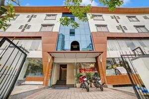 two motorcycles parked in front of a building at Townhouse OAK Ess Jay in Bangalore