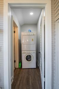 a laundry room with a washer and dryer at Southern Sophistication and Charm in the Heart of Cooper Young in Memphis