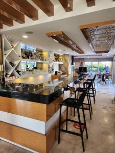 a bar in a restaurant with black stools at Esperanza Hotel in Antalya