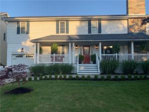 uma casa branca com uma porta vermelha e um quintal em Centre Gate House Licence# 117-2023 em Niagara-on-the-Lake