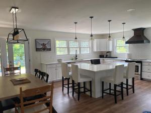 a kitchen and dining room with a table and chairs at Centre Gate House Licence# 117-2023 in Niagara-on-the-Lake