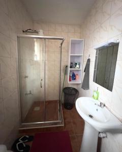 a bathroom with a shower and a sink at Kithinji Apartments in Nairobi