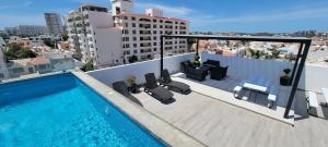 a swimming pool on the roof of a building at New Luxury Condo in Mazatlán