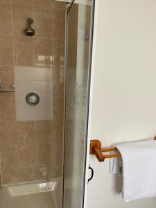 a shower with a glass door next to a towel at Ger's in Galway