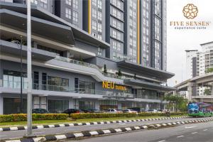 a new sites building with cars parked in front of it at Neu Suites Residence KLCC, Five Senses in Kuala Lumpur